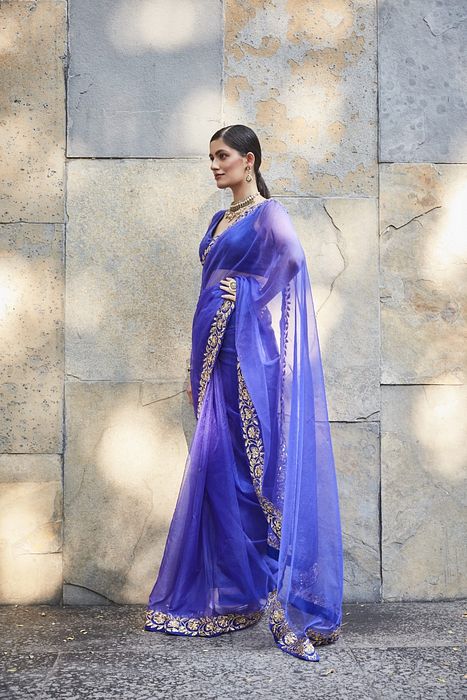 A model showcasing Purple Silk Organza Saree by Ranian from Ranian's collection A model showcasing Purple Silk Organza Saree by Ranian from Ranian's collection