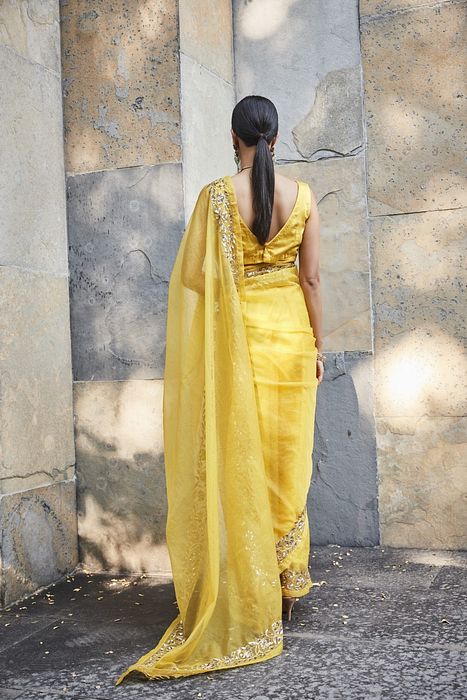 A model showcasing Yellow Silk Organza Saree by Ranian from Ranian's collection A model showcasing Yellow Silk Organza Saree by Ranian from Ranian's collection