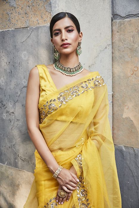 A model showcasing Yellow Silk Organza Saree by Ranian from Ranian's collection A model showcasing Yellow Silk Organza Saree by Ranian from Ranian's collection