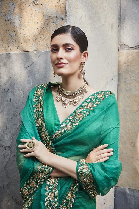 A model showcasing Green Silk Organza Saree by Ranian from Ranian's collection A model showcasing Green Silk Organza Saree by Ranian from Ranian's collection