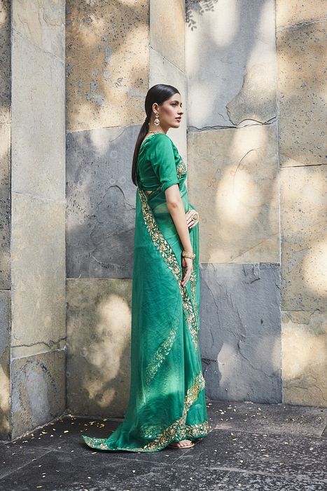 A model showcasing Green Silk Organza Saree by Ranian from Ranian's collection A model showcasing Green Silk Organza Saree by Ranian from Ranian's collection