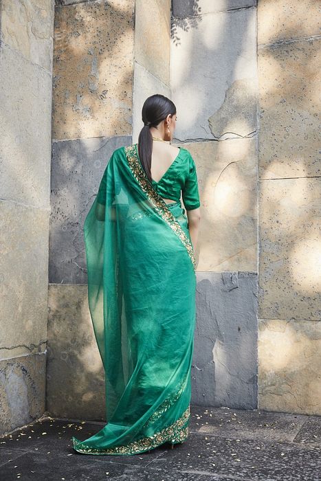 A model showcasing Green Silk Organza Saree by Ranian from Ranian's collection A model showcasing Green Silk Organza Saree by Ranian from Ranian's collection