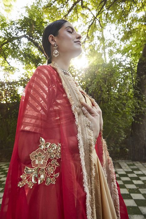 A model showcasing Gold Silk Lehenga by Ranian from Ranian's collection A model showcasing Gold Silk Lehenga by Ranian from Ranian's collection