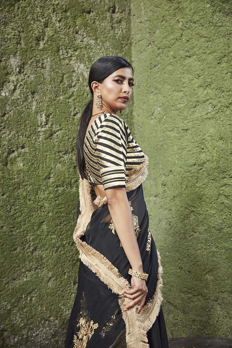 A model showcasing Black Silk Lehenga by Ranian from Ranian's collection A model showcasing Black Silk Lehenga by Ranian from Ranian's collection