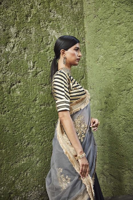 A model showcasing Black And Grey Silk Lehenga by Ranian from Ranian's collection A model showcasing Black And Grey Silk Lehenga by Ranian from Ranian's collection