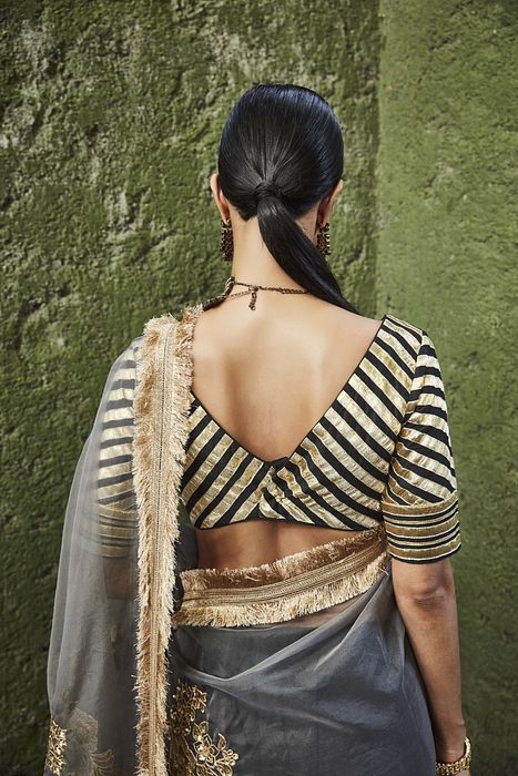 A model showcasing Black And Grey Silk Lehenga by Ranian from Ranian's collection A model showcasing Black And Grey Silk Lehenga by Ranian from Ranian's collection