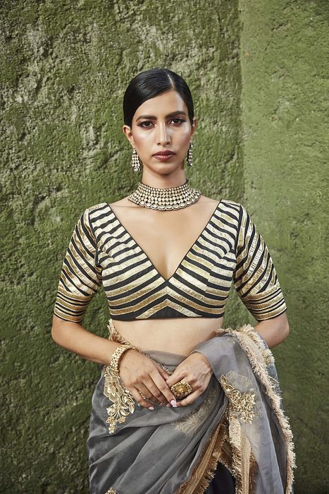 A model showcasing Black And Grey Silk Lehenga by Ranian from Ranian's collection A model showcasing Black And Grey Silk Lehenga by Ranian from Ranian's collection
