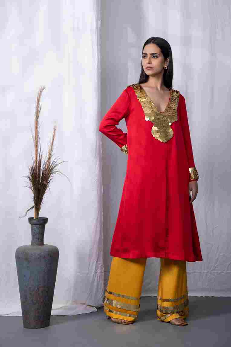 A model showcasing Red Sunboarding Kurta Set by Kanika Verma Couture from Kanika Verma Couture's collection