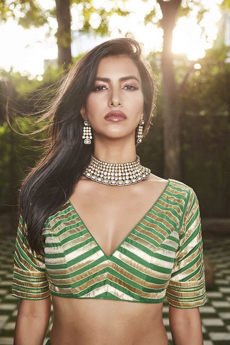 A model showcasing Green Silk Lehenga by Ranian from Ranian's collection A model showcasing Green Silk Lehenga by Ranian from Ranian's collection