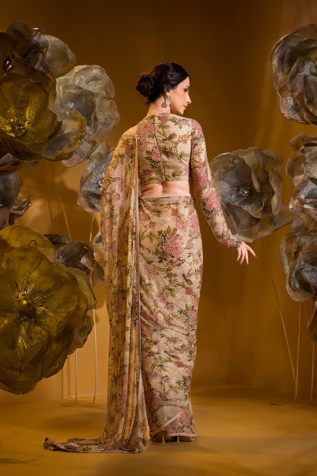 A model showcasing Printed Beige Saree With One Sleeve Blouse by Q By Sonia Baderia from Q By Sonia Baderia's collection