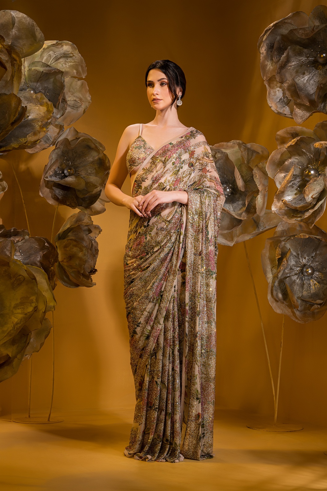 A model showcasing Printed Beige Saree With Bralette Blouse by Q By Sonia Baderia from Q By Sonia Baderia's collection