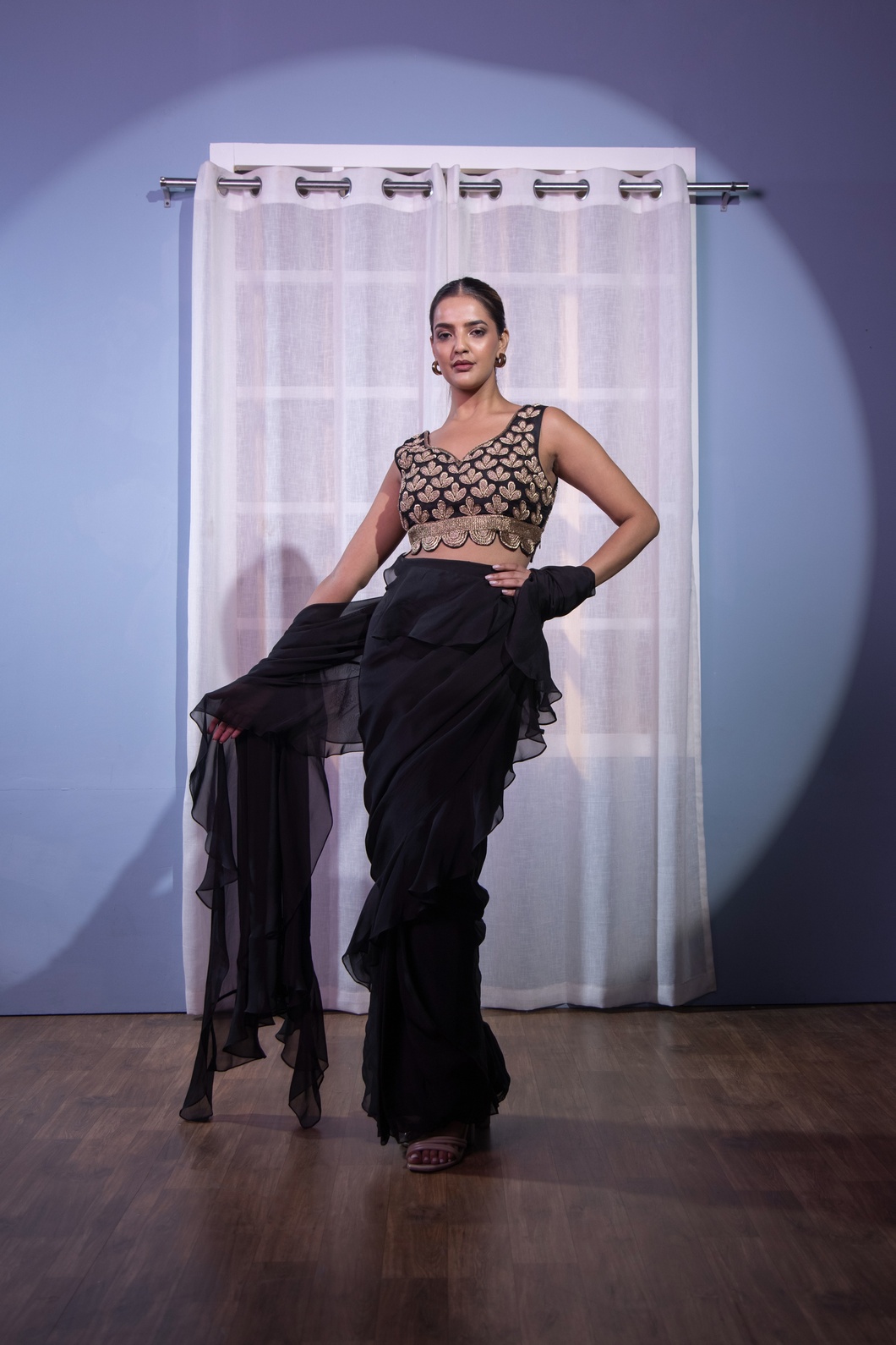 A model showcasing Black Ruffle Saree Dabka by Kanika Verma Couture from Kanika Verma Couture's collection A model showcasing Black Ruffle Saree Dabka by Kanika Verma Couture from Kanika Verma Couture's collection