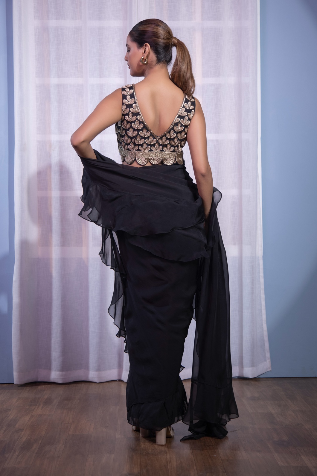 A model showcasing Black Ruffle Saree Dabka by Kanika Verma Couture from Kanika Verma Couture's collection A model showcasing Black Ruffle Saree Dabka by Kanika Verma Couture from Kanika Verma Couture's collection