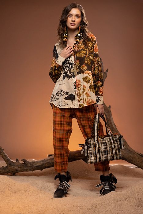 A model showcasing Orange Black Check Pants by Capisvirleo from Capisvirleo's collection A model showcasing Orange Black Check Pants by Capisvirleo from Capisvirleo's collection