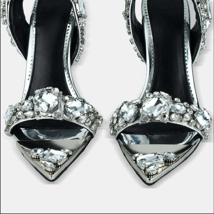 A model showcasing Silver Metallic Leather Pointed Toe Sandals by Elleganti from Elleganti's collection A model showcasing Silver Metallic Leather Pointed Toe Sandals by Elleganti from Elleganti's collection