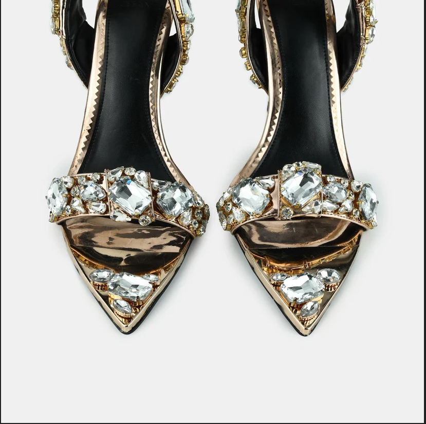 A model showcasing Champagne Gold Metallic Leather Pointed Toe Sandals by Elleganti from Elleganti's collection A model showcasing Champagne Gold Metallic Leather Pointed Toe Sandals by Elleganti from Elleganti's collection