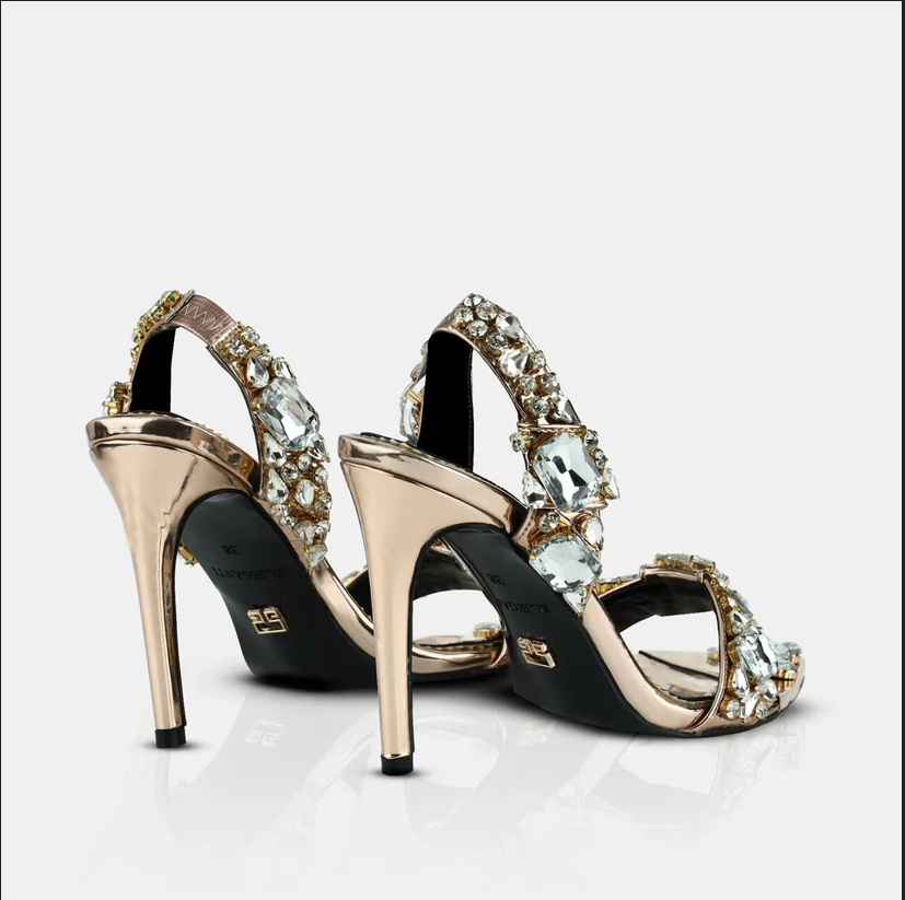 A model showcasing Champagne Gold Metallic Leather Pointed Toe Sandals by Elleganti from Elleganti's collection A model showcasing Champagne Gold Metallic Leather Pointed Toe Sandals by Elleganti from Elleganti's collection