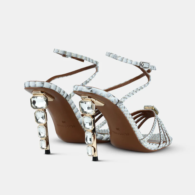 A model showcasing Whitegold Metallic Snake Printed Leather Sandals by Elleganti from Elleganti's collection A model showcasing Whitegold Metallic Snake Printed Leather Sandals by Elleganti from Elleganti's collection