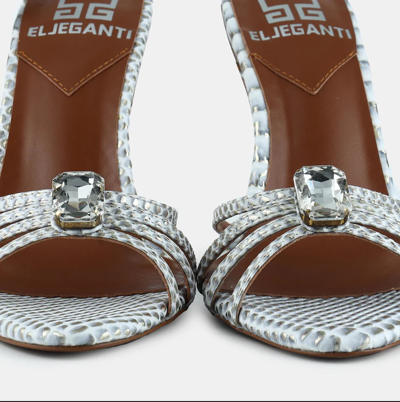 A model showcasing Whitegold Metallic Snake Printed Leather Sandals by Elleganti from Elleganti's collection A model showcasing Whitegold Metallic Snake Printed Leather Sandals by Elleganti from Elleganti's collection