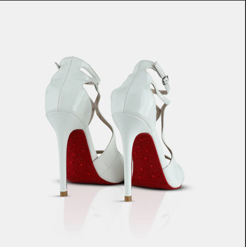 A model showcasing White Patent Leather Mule Sandals by Elleganti from Elleganti's collection A model showcasing White Patent Leather Mule Sandals by Elleganti from Elleganti's collection