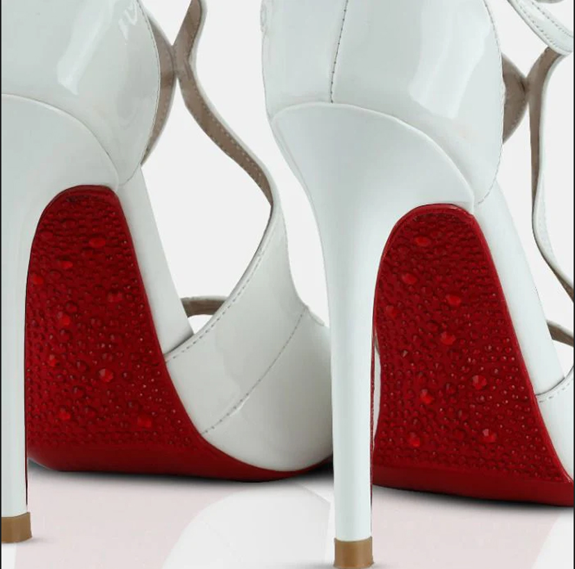 A model showcasing White Patent Leather Mule Sandals by Elleganti from Elleganti's collection A model showcasing White Patent Leather Mule Sandals by Elleganti from Elleganti's collection