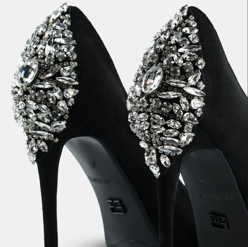 A model showcasing Suede Leather Pointed Toe Pumps by Elleganti from Elleganti's collection A model showcasing Suede Leather Pointed Toe Pumps by Elleganti from Elleganti's collection