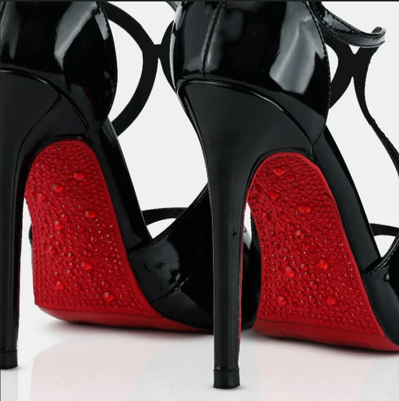 A model showcasing Black Patent Leather Crystal Sandals by Elleganti from Elleganti's collection