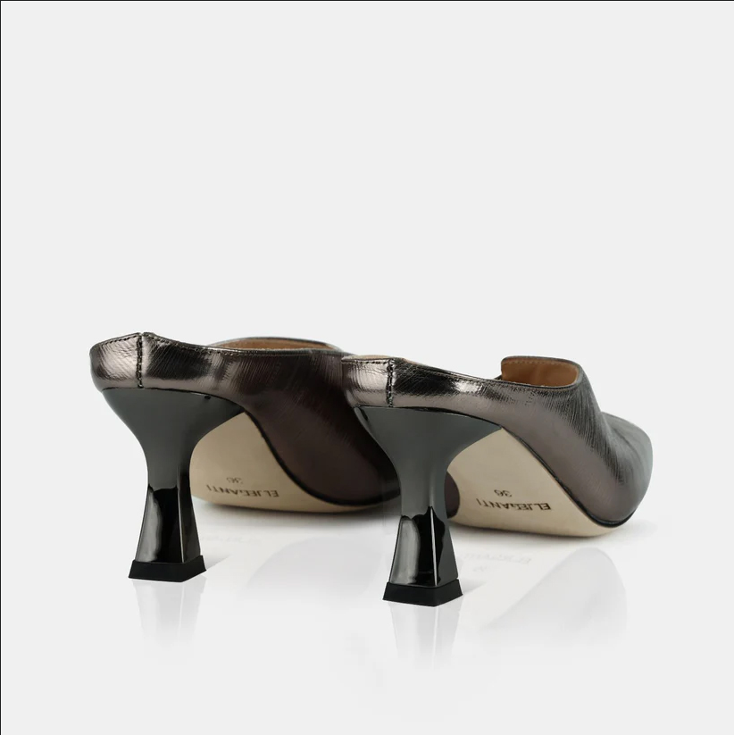 A model showcasing Gun Colored Leather Mule Sandals by Elleganti from Elleganti's collection A model showcasing Gun Colored Leather Mule Sandals by Elleganti from Elleganti's collection