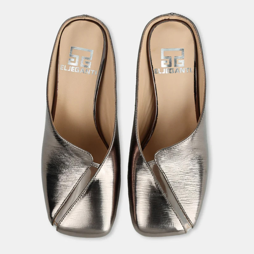 A model showcasing Gun Colored Leather Mule Sandals by Elleganti from Elleganti's collection A model showcasing Gun Colored Leather Mule Sandals by Elleganti from Elleganti's collection