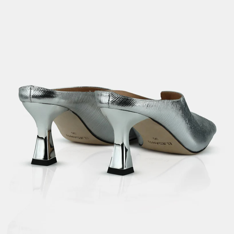 A model showcasing Silver Colored Leather Mule Sandals by Elleganti from Elleganti's collection A model showcasing Silver Colored Leather Mule Sandals by Elleganti from Elleganti's collection