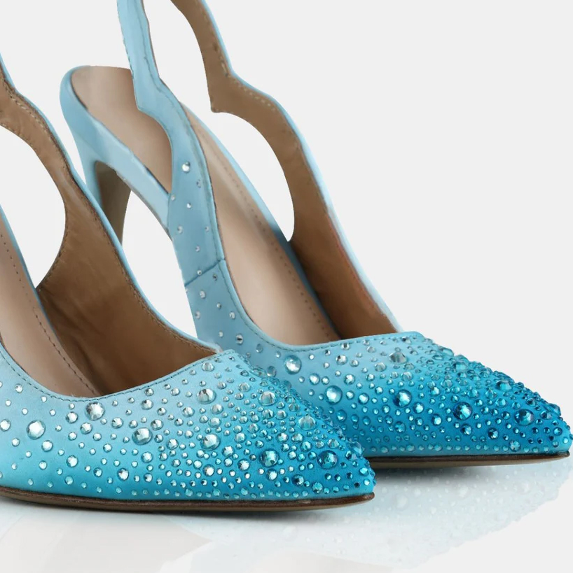 A model showcasing Crystal Pointed Toe Sling Back Pumps by Elleganti from Elleganti's collection A model showcasing Crystal Pointed Toe Sling Back Pumps by Elleganti from Elleganti's collection