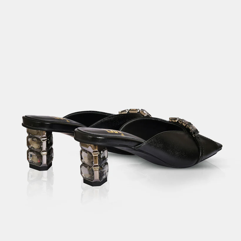 A model showcasing Black Metallic Leather Sandals With Crystal Heel by Elleganti from Elleganti's collection A model showcasing Black Metallic Leather Sandals With Crystal Heel by Elleganti from Elleganti's collection
