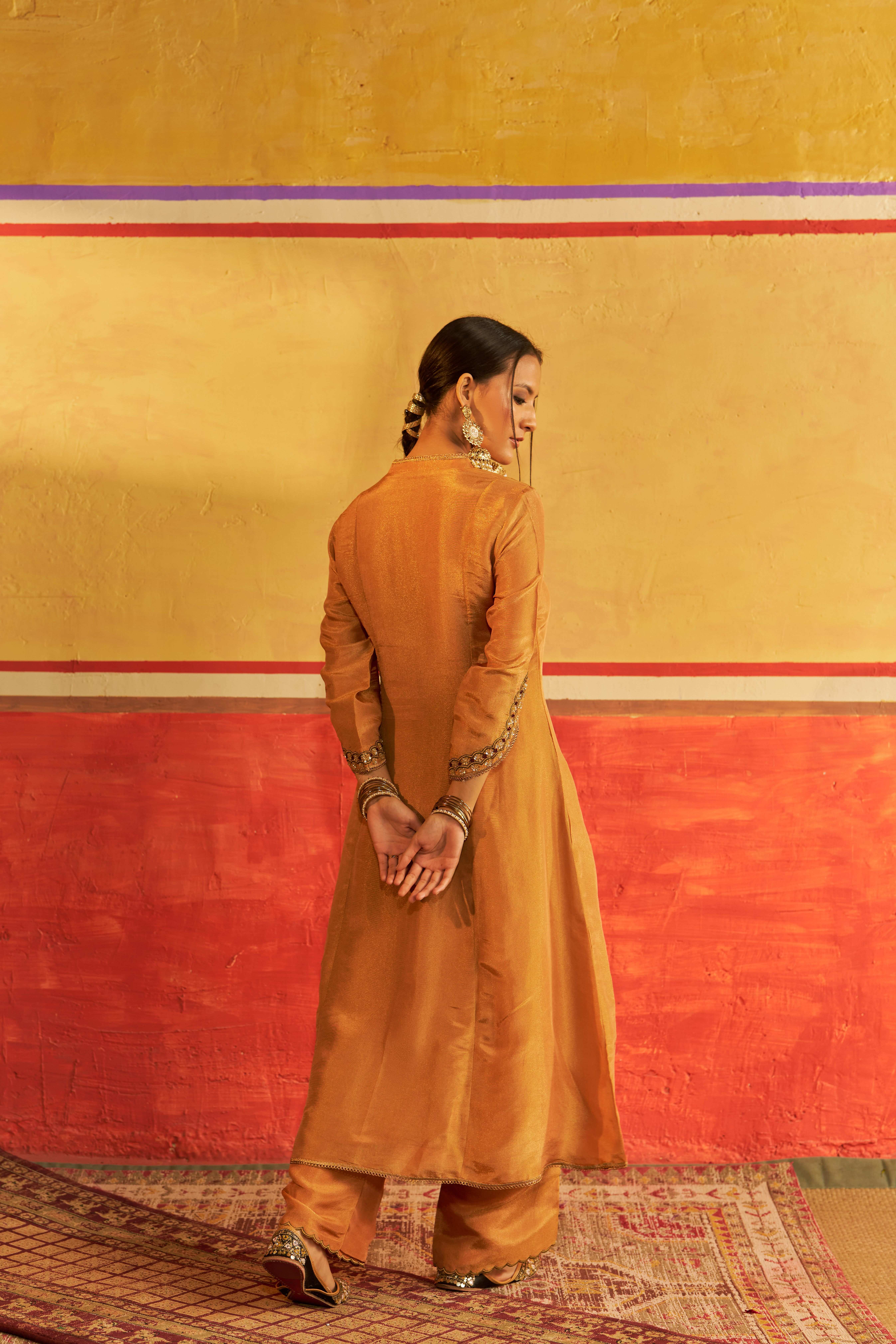 A model showcasing Meera Golden Kurta Set With Dupatta by Gaamya from Gaamya's collection