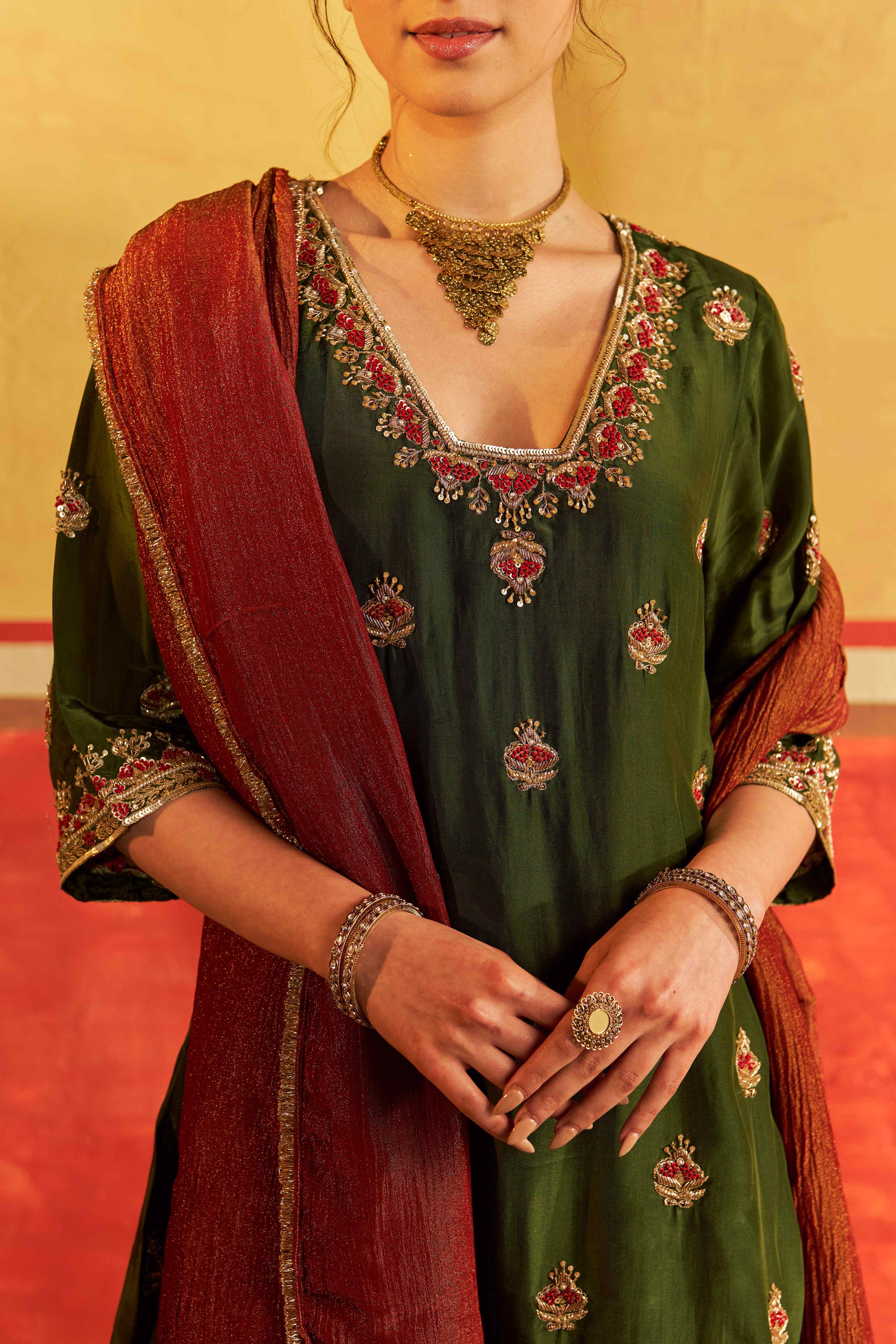 A model showcasing Sahiba Mehendi Green Suit With Dupatta by Gaamya from Gaamya's collection