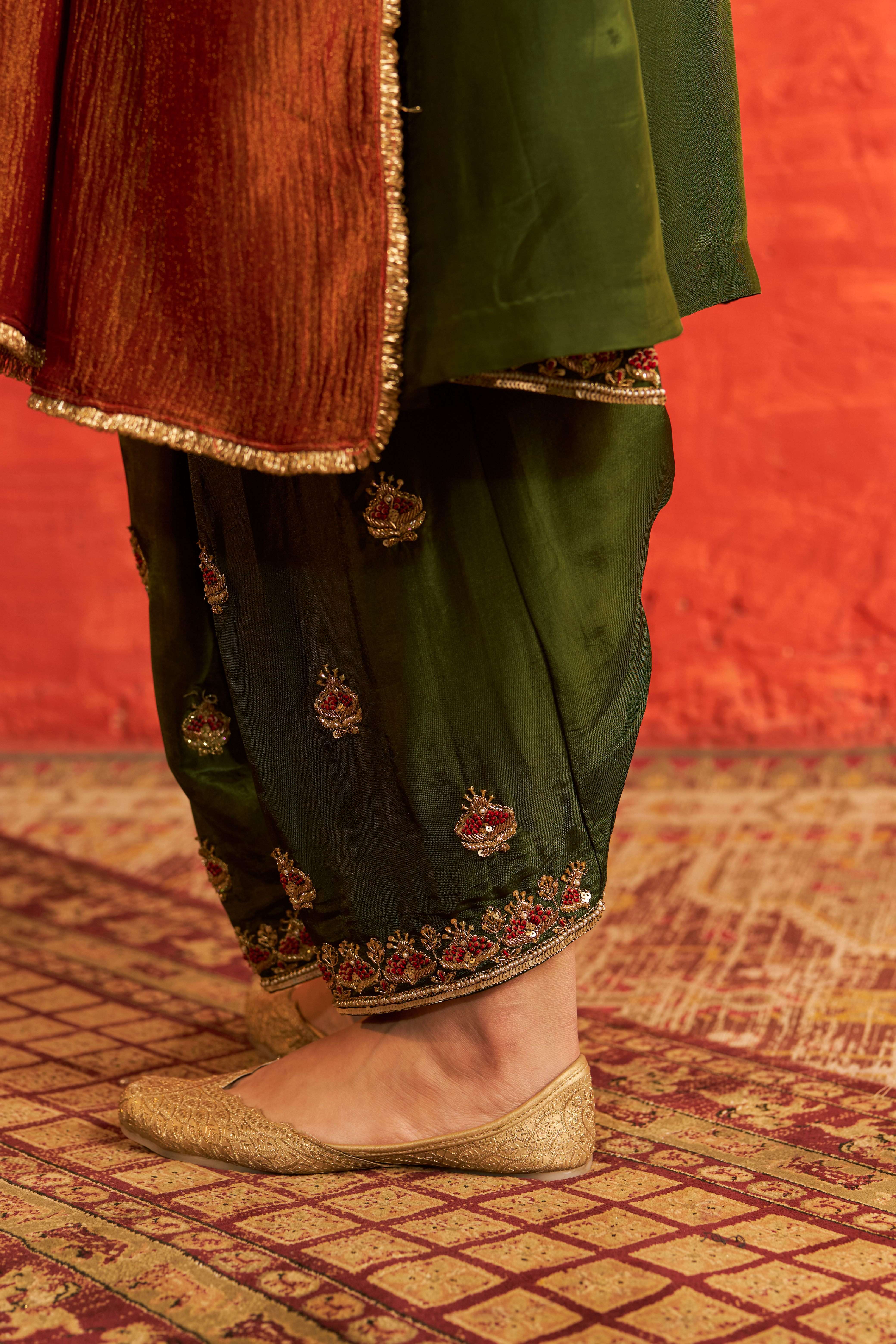 A model showcasing Sahiba Mehendi Green Suit With Dupatta by Gaamya from Gaamya's collection
