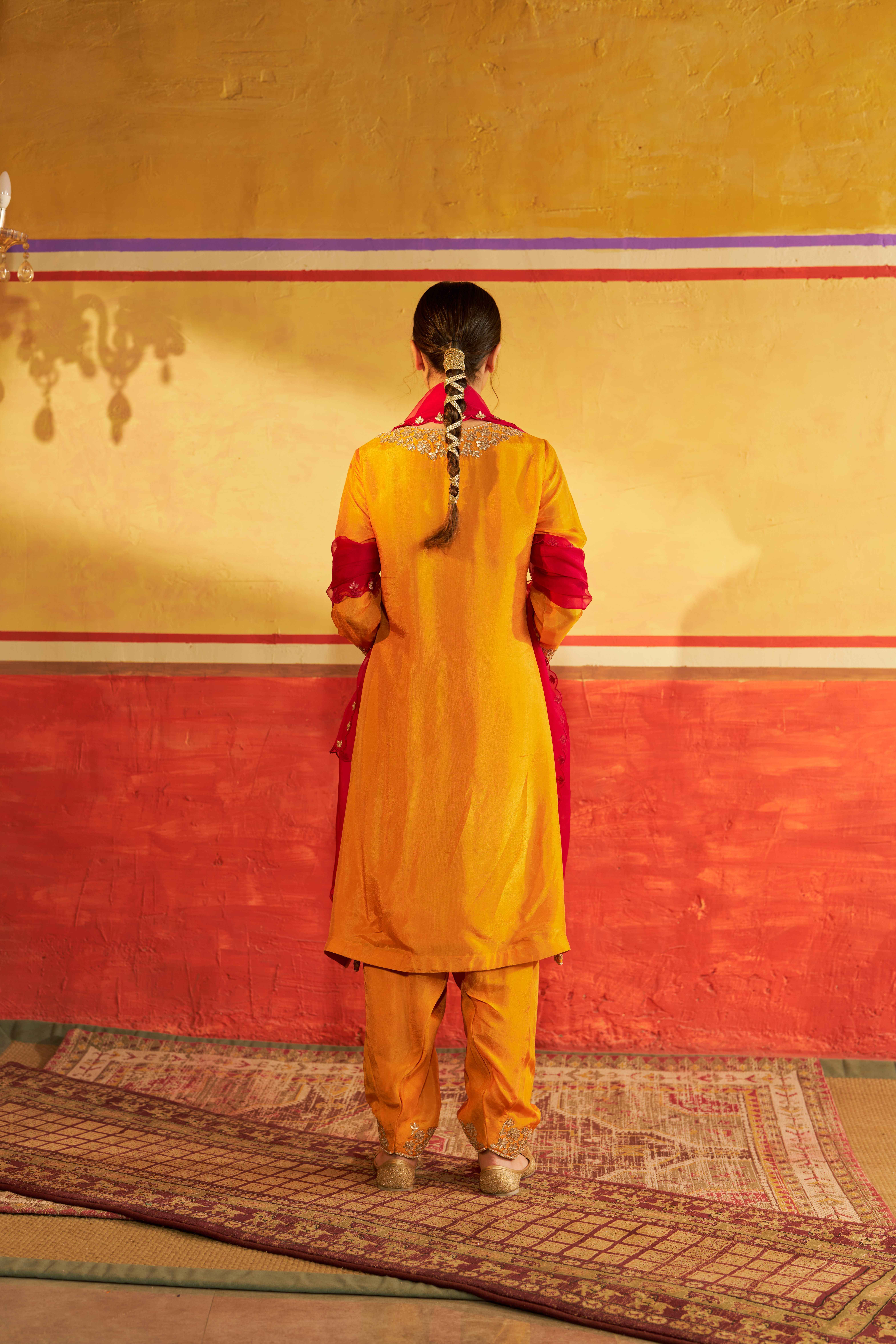 A model showcasing Miraas Yellow Kurta Suit With Dupatta by Gaamya from Gaamya's collection