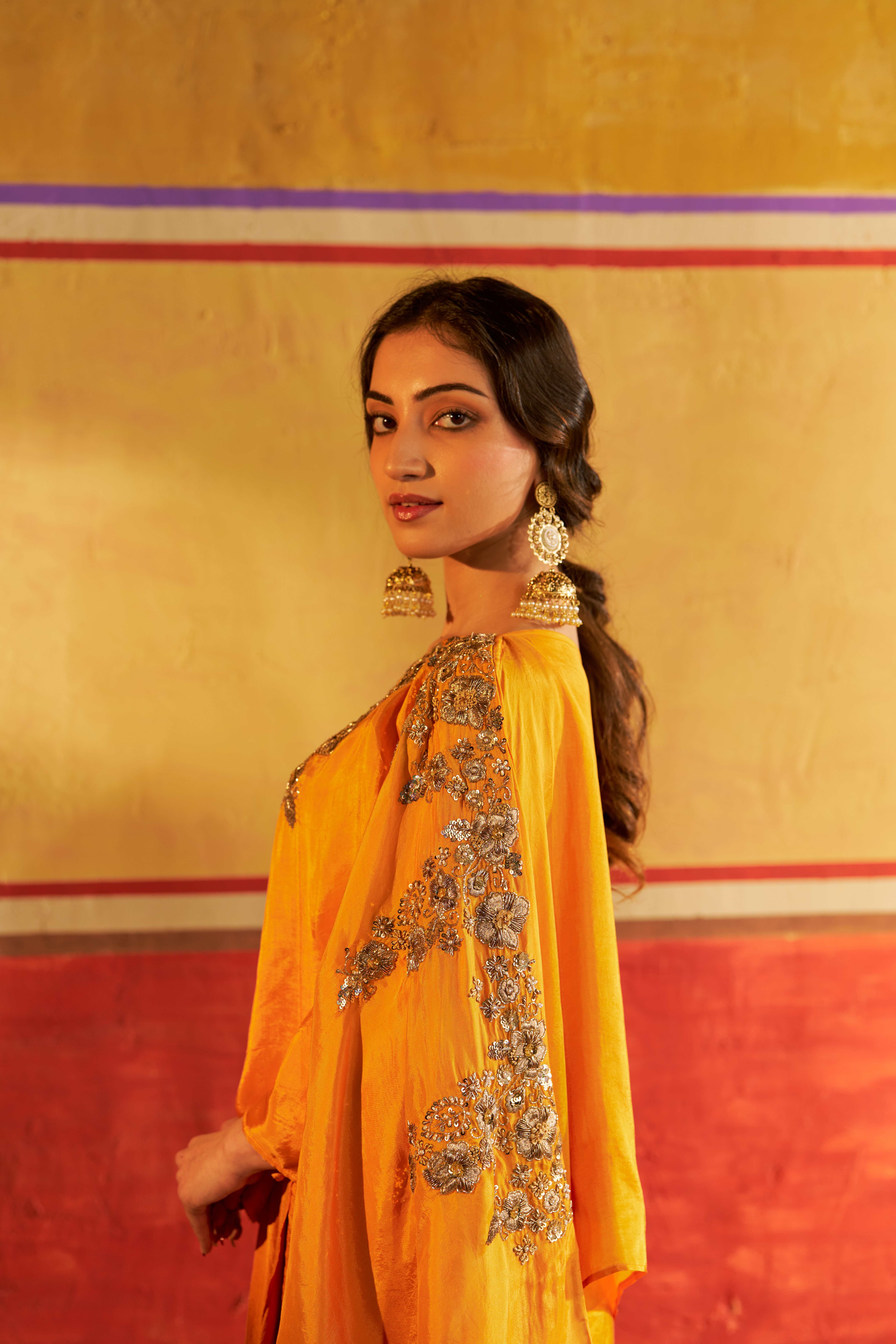 A model showcasing Sitara Yellow Kaftan Set by Gaamya from Gaamya's collection