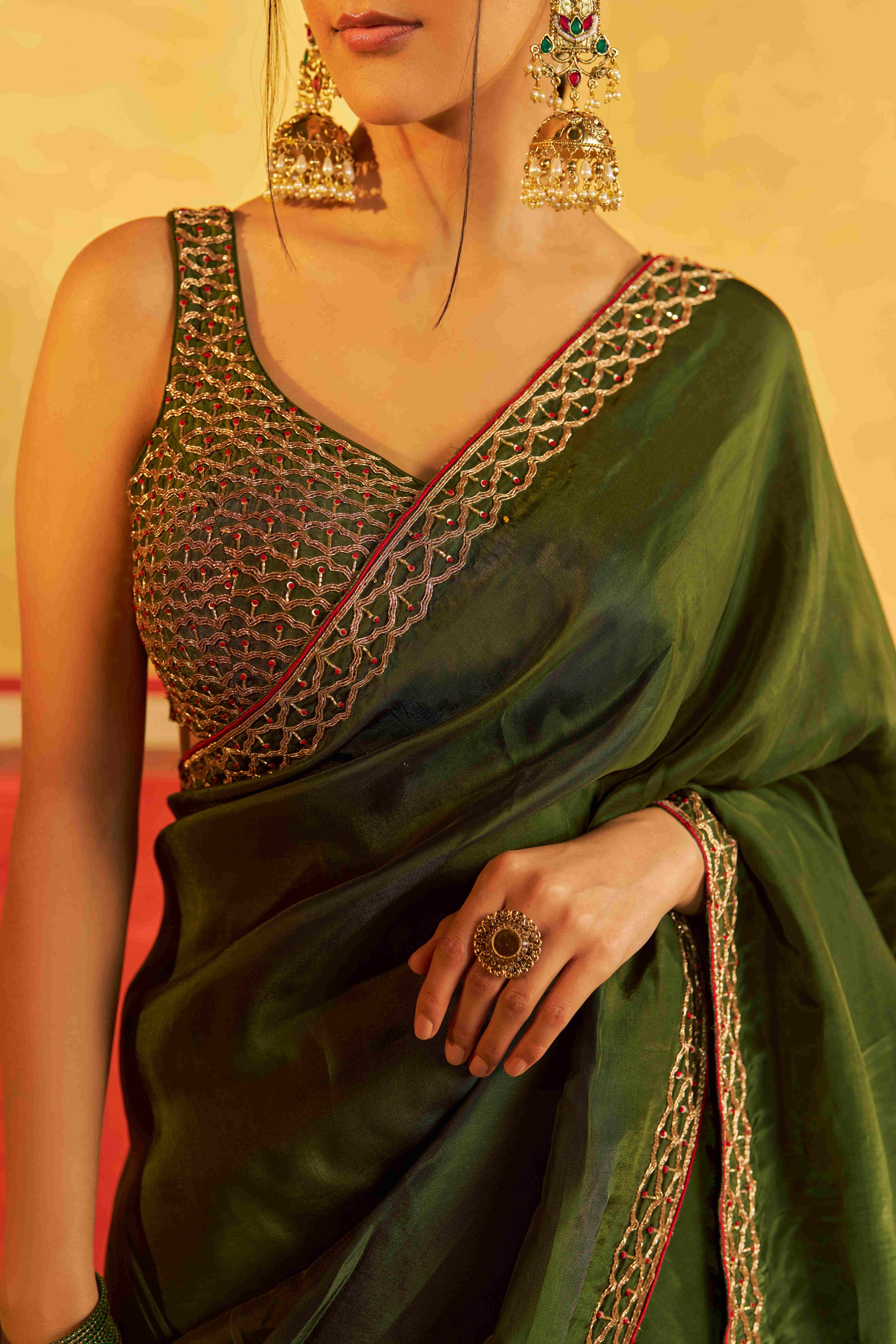 A model showcasing Chahat Mehendi Green Saree With Blouse by Gaamya from Gaamya's collection