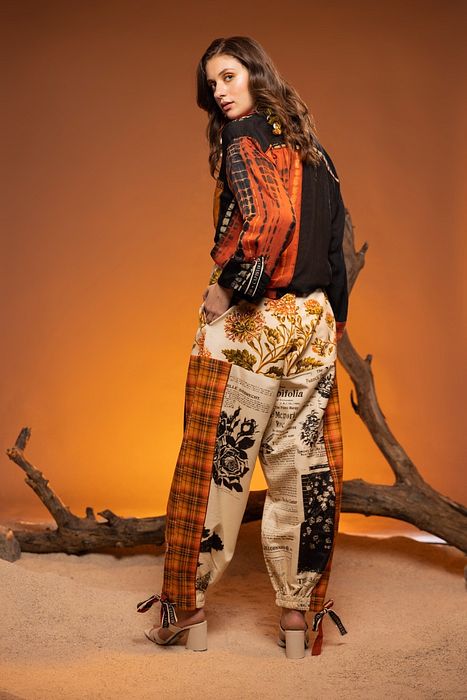 A model showcasing Ivory Cedar Pants by Capisvirleo from Capisvirleo's collection