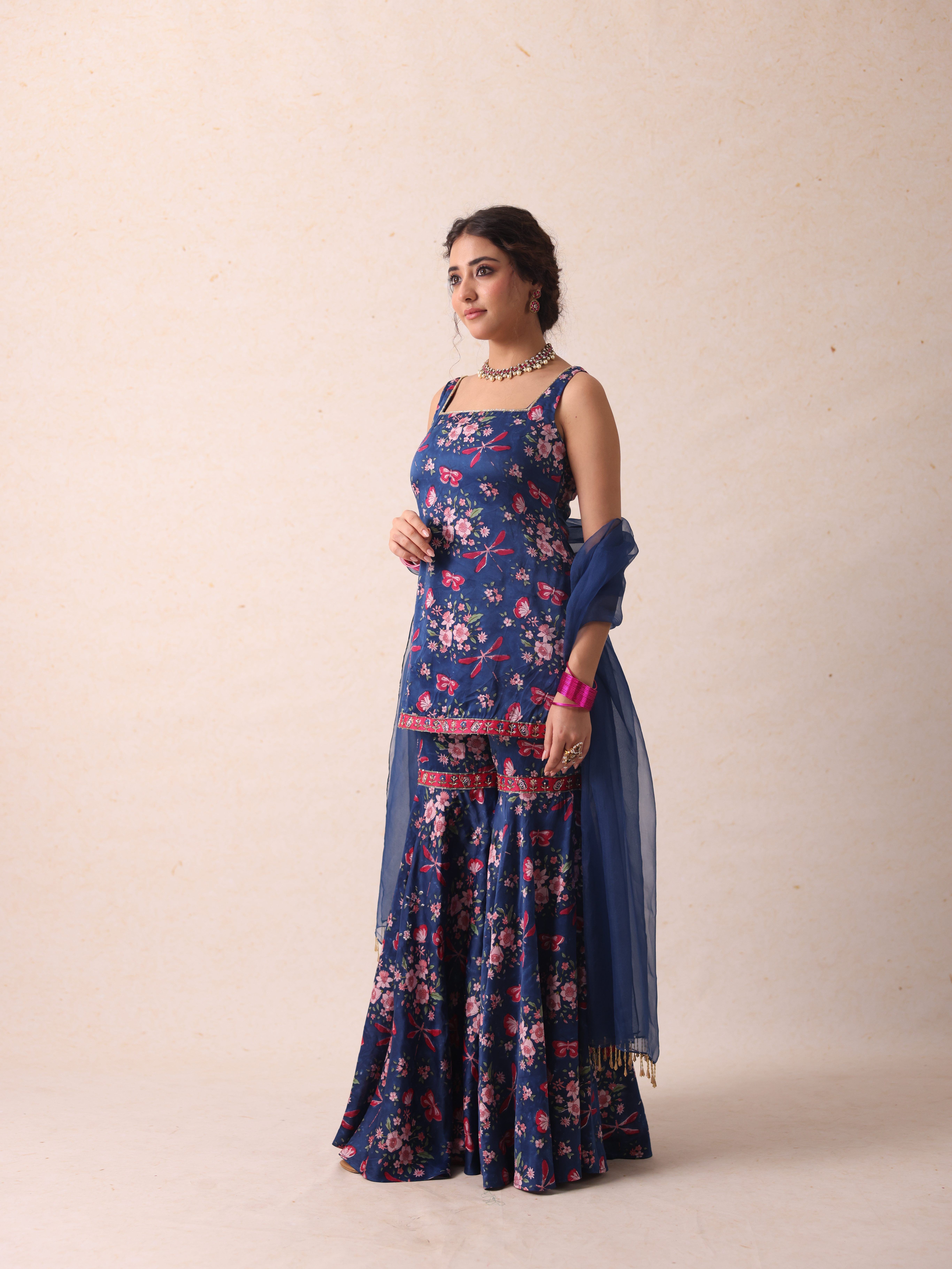 A model showcasing Jaya Blue Sharara by Gaamya from Gaamya's collection