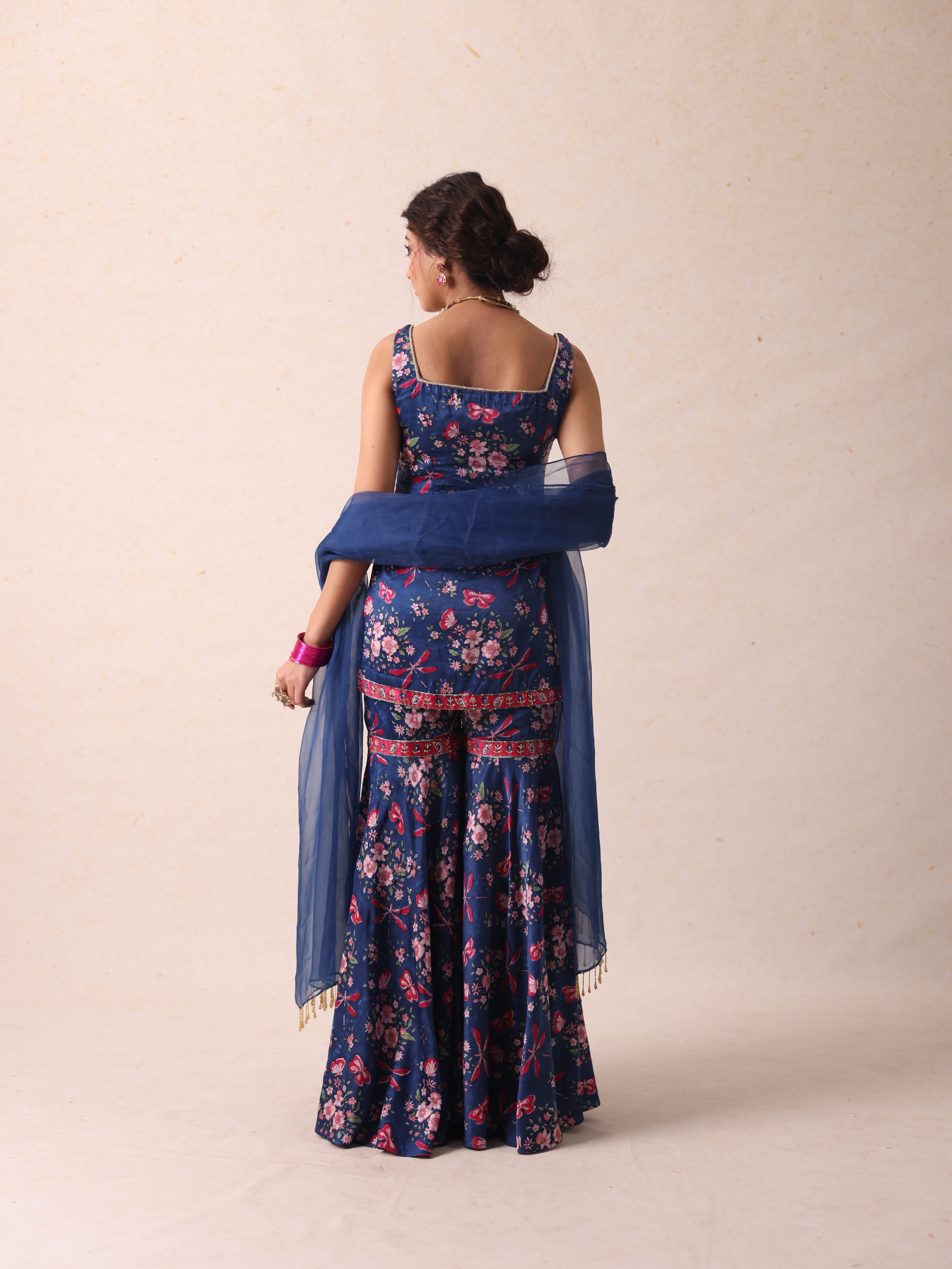 A model showcasing Jaya Blue Sharara by Gaamya from Gaamya's collection
