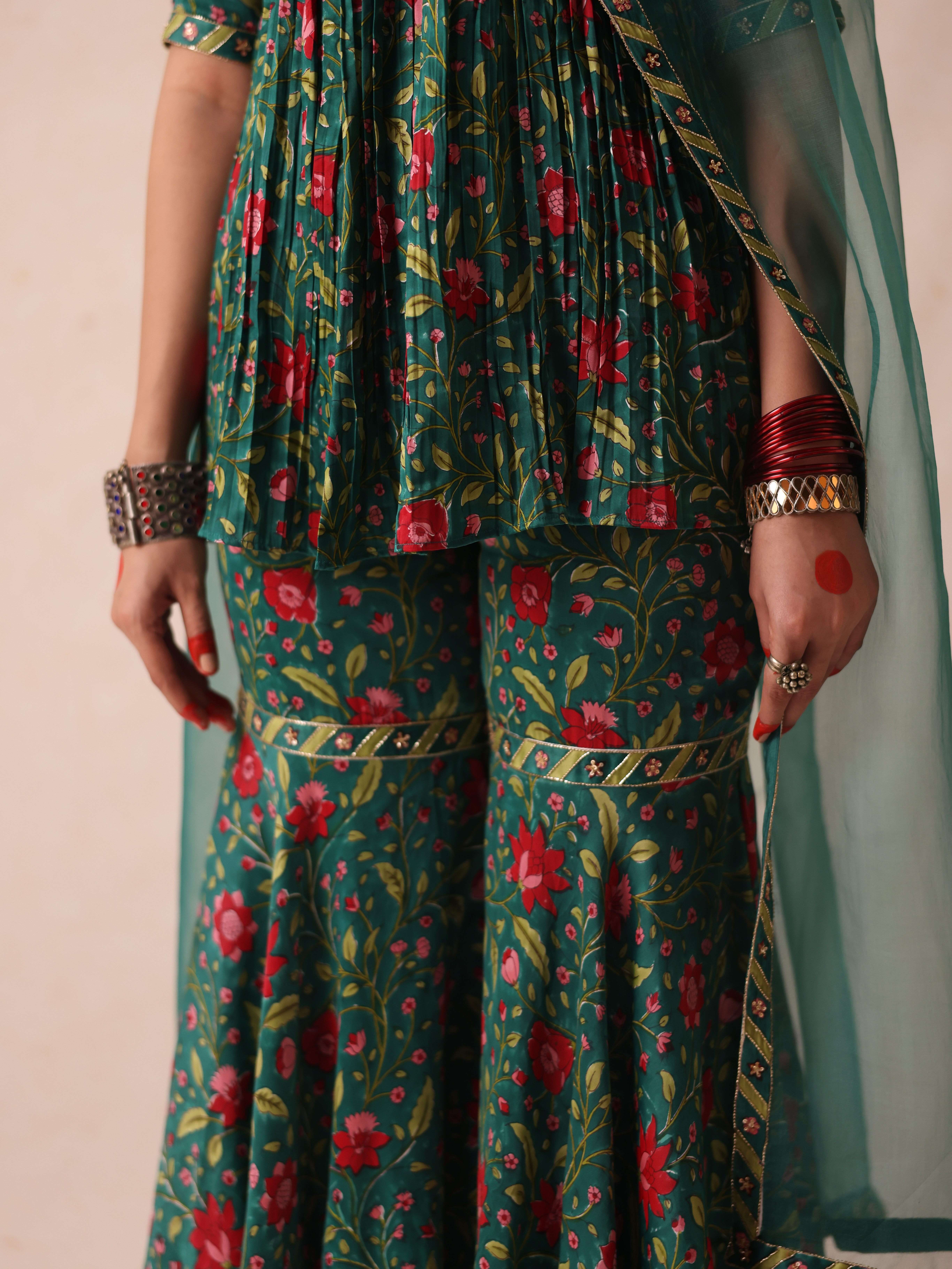 A model showcasing Sonia Green Sharara by Gaamya from Gaamya's collection A model showcasing Sonia Green Sharara by Gaamya from Gaamya's collection