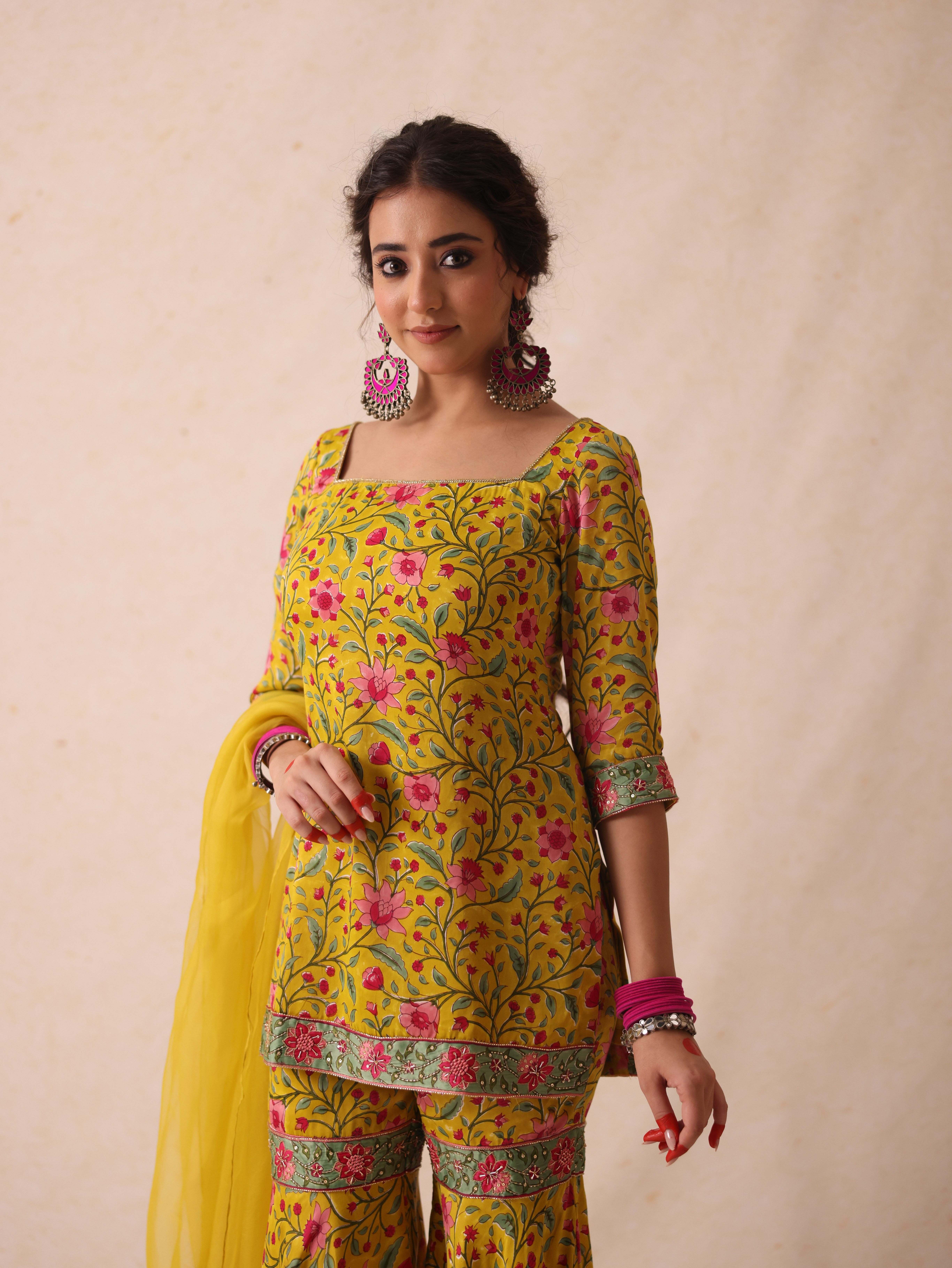 A model showcasing Simar Yellow Sharara Set by Gaamya from Gaamya's collection