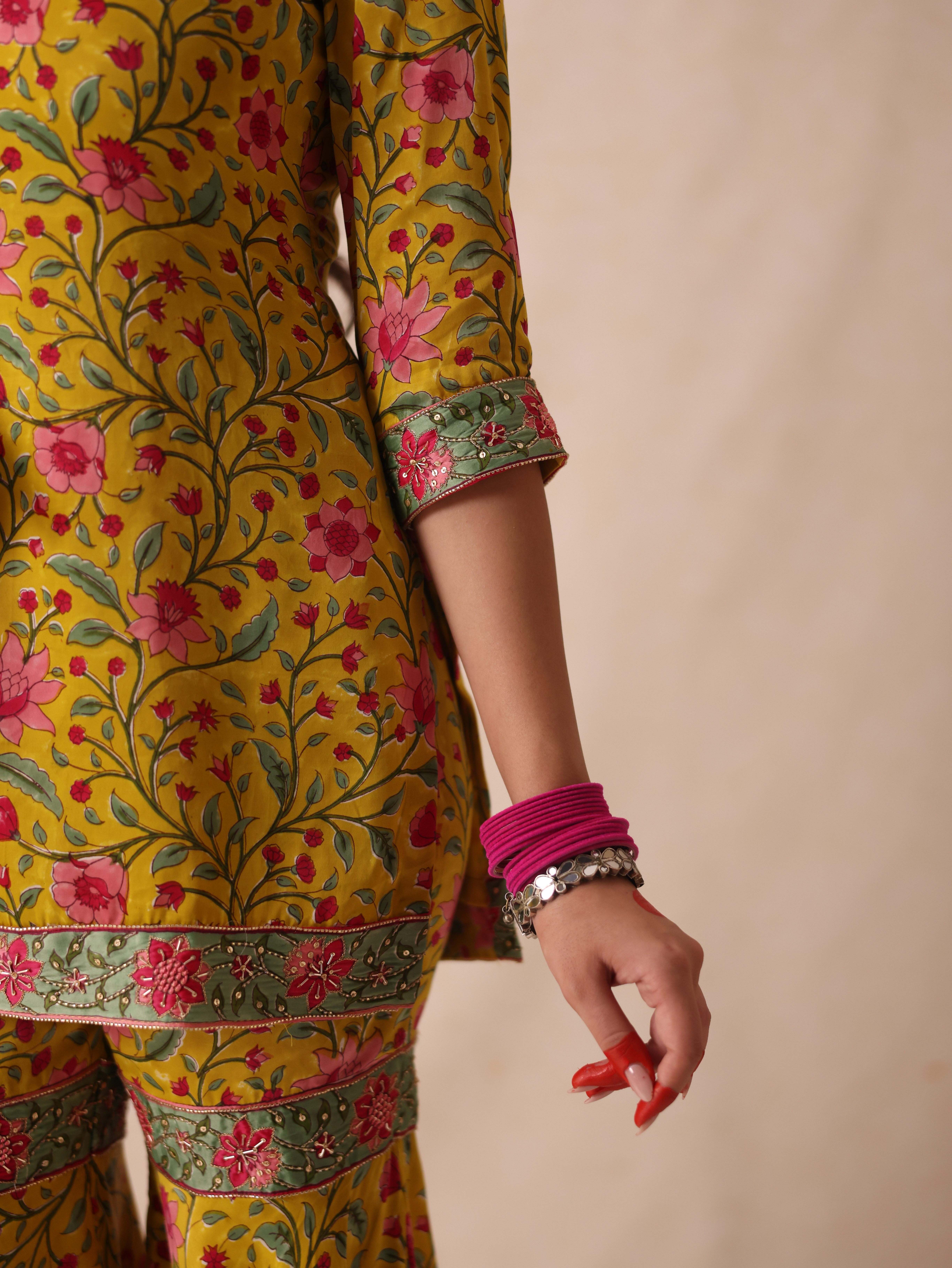 A model showcasing Simar Yellow Sharara Set by Gaamya from Gaamya's collection