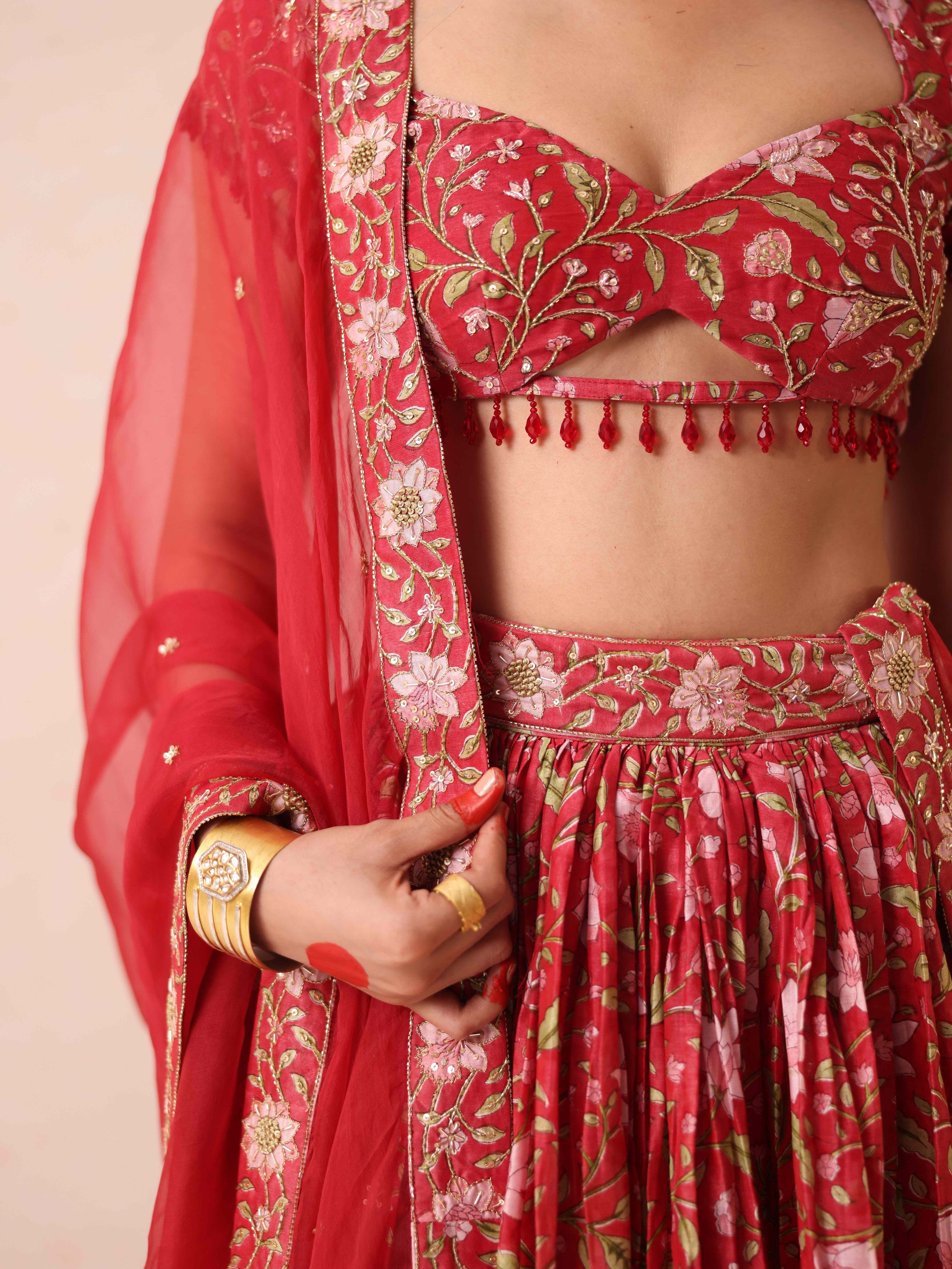 A model showcasing Shashi Red Lehenga by Gaamya from Gaamya's collection
