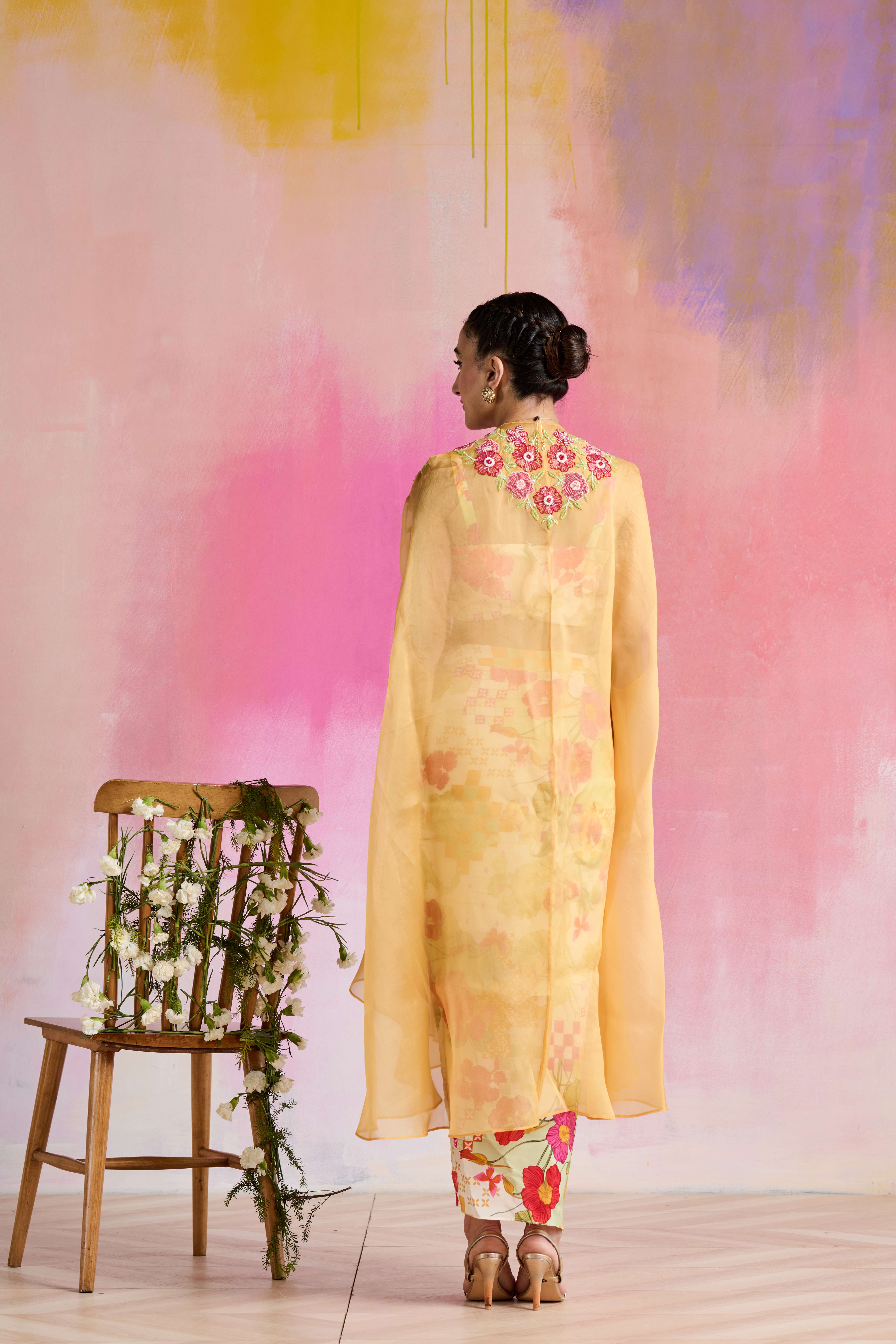 A model showcasing Aarna Cape Set by Nirvair from Nirvair's collection