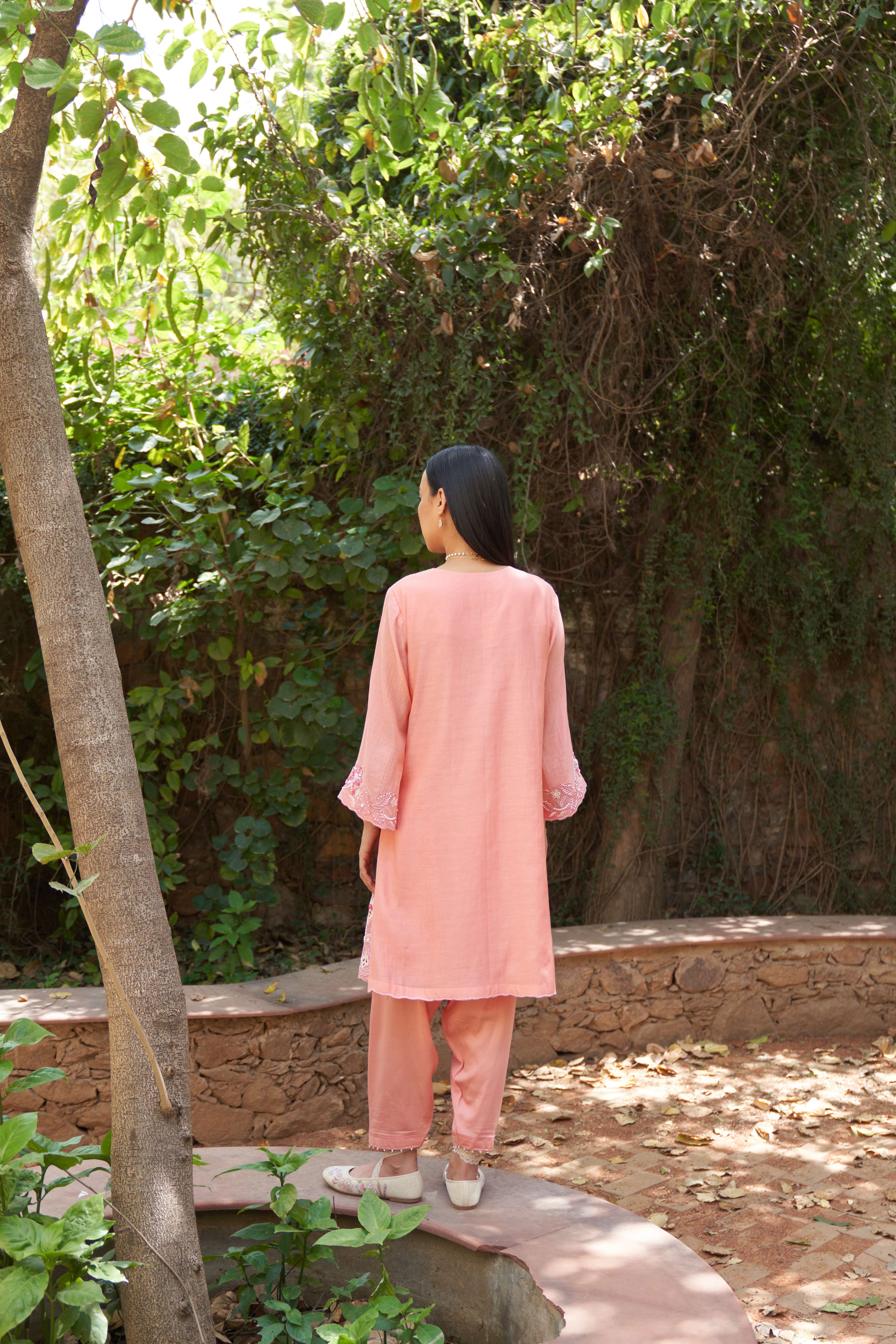 A model showcasing Azalea Peach Bloom Kurta Set by Nirvair from Nirvair's collection