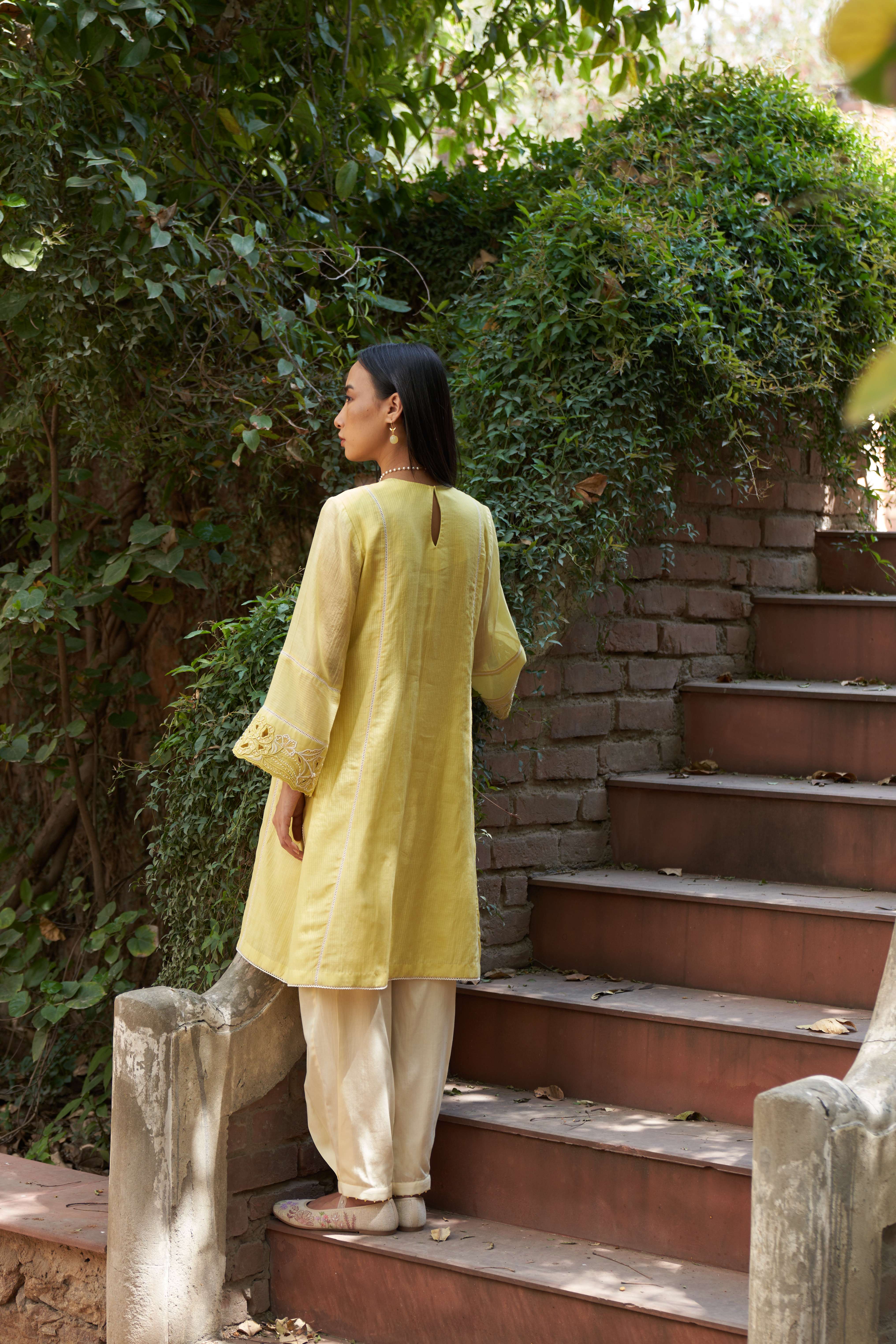 A model showcasing Cosmos Lemon Zest Kurta Set by Nirvair from Nirvair's collection