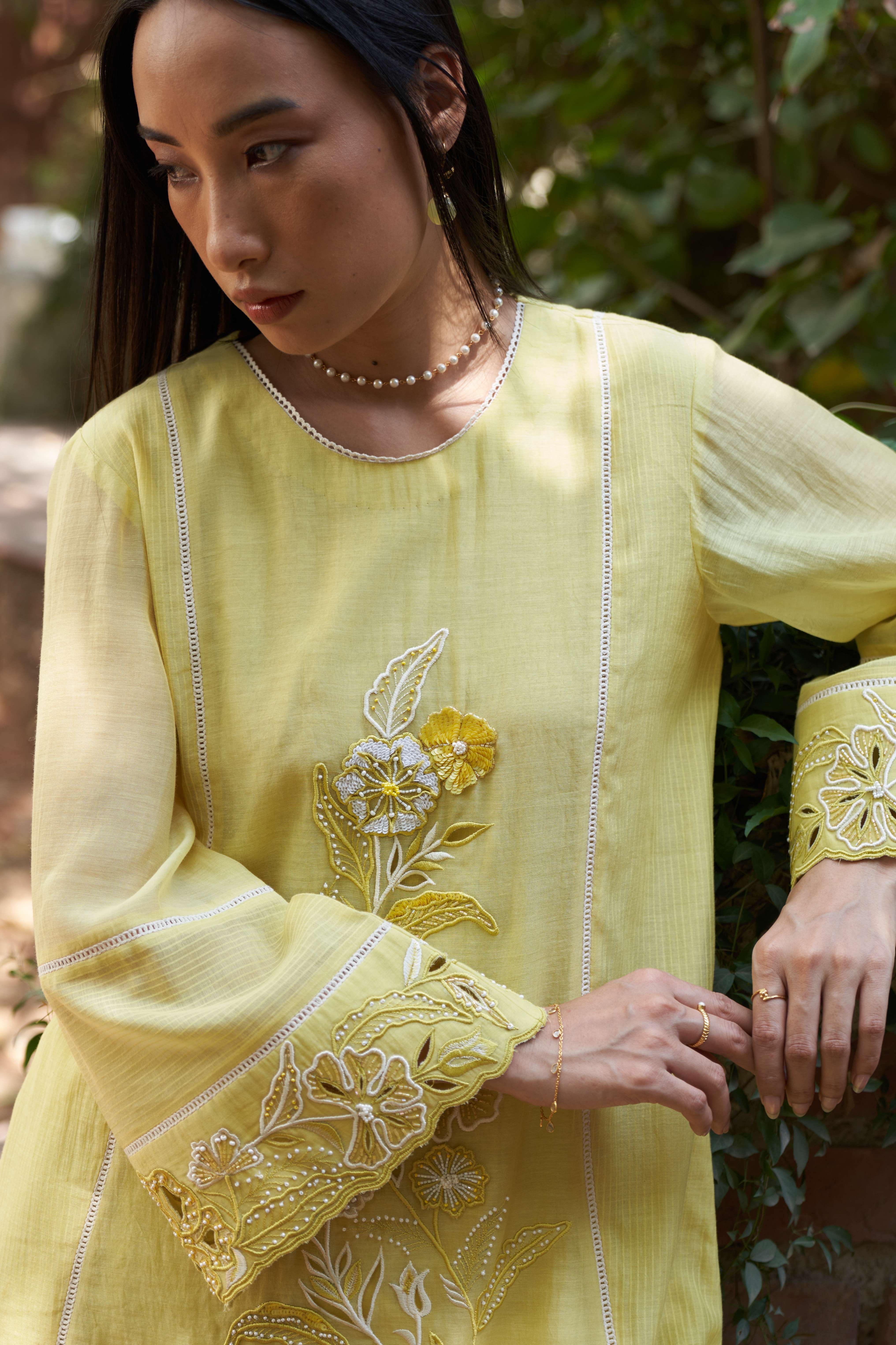 A model showcasing Cosmos Lemon Zest Kurta Set by Nirvair from Nirvair's collection