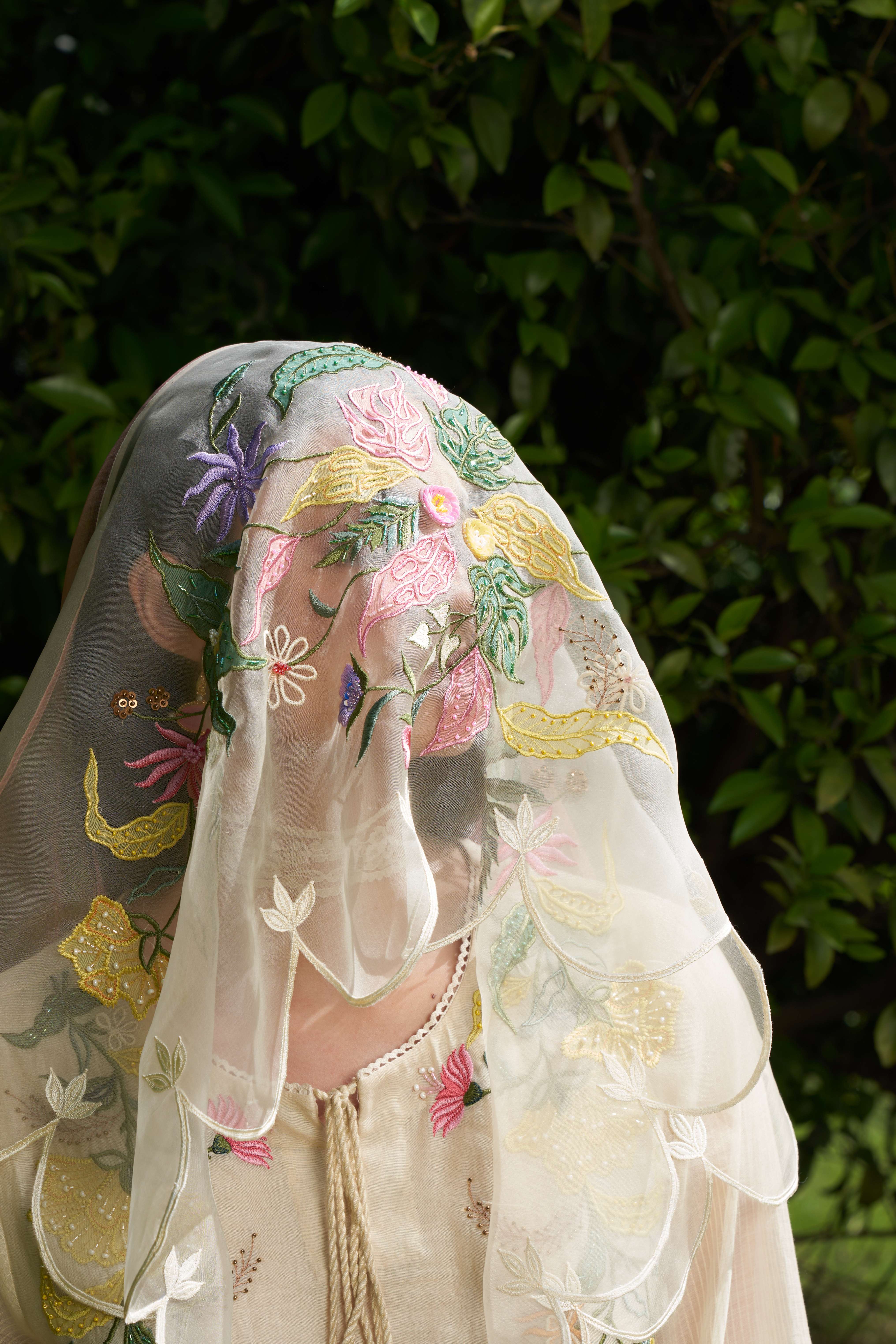 A model showcasing Peach Block Embroidered Organza Dupatta by Nirvair from Nirvair's collection A model showcasing Peach Block Embroidered Organza Dupatta by Nirvair from Nirvair's collection
